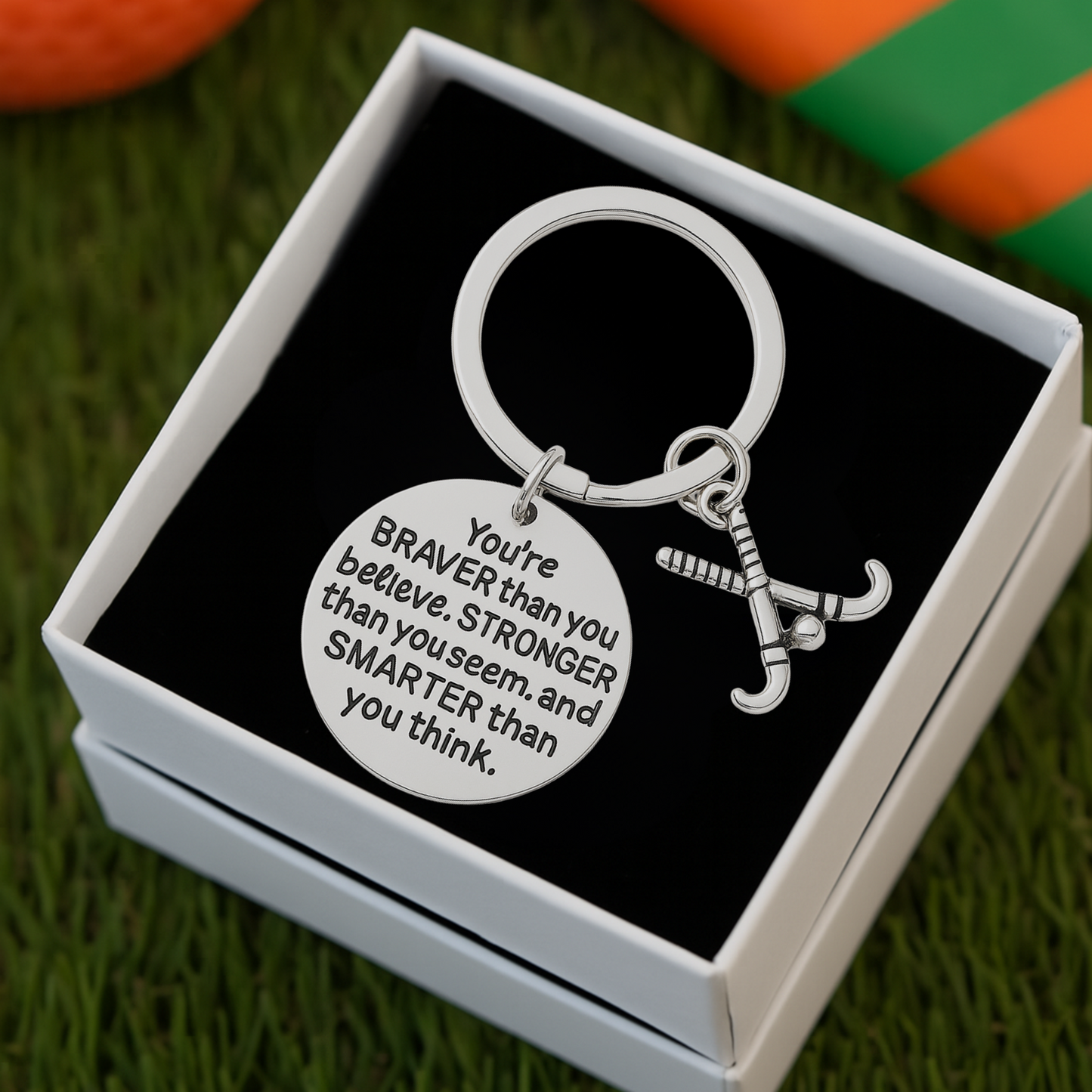 Field hockey charm keychain displayed in gift box, perfect sports gift for players and teammates