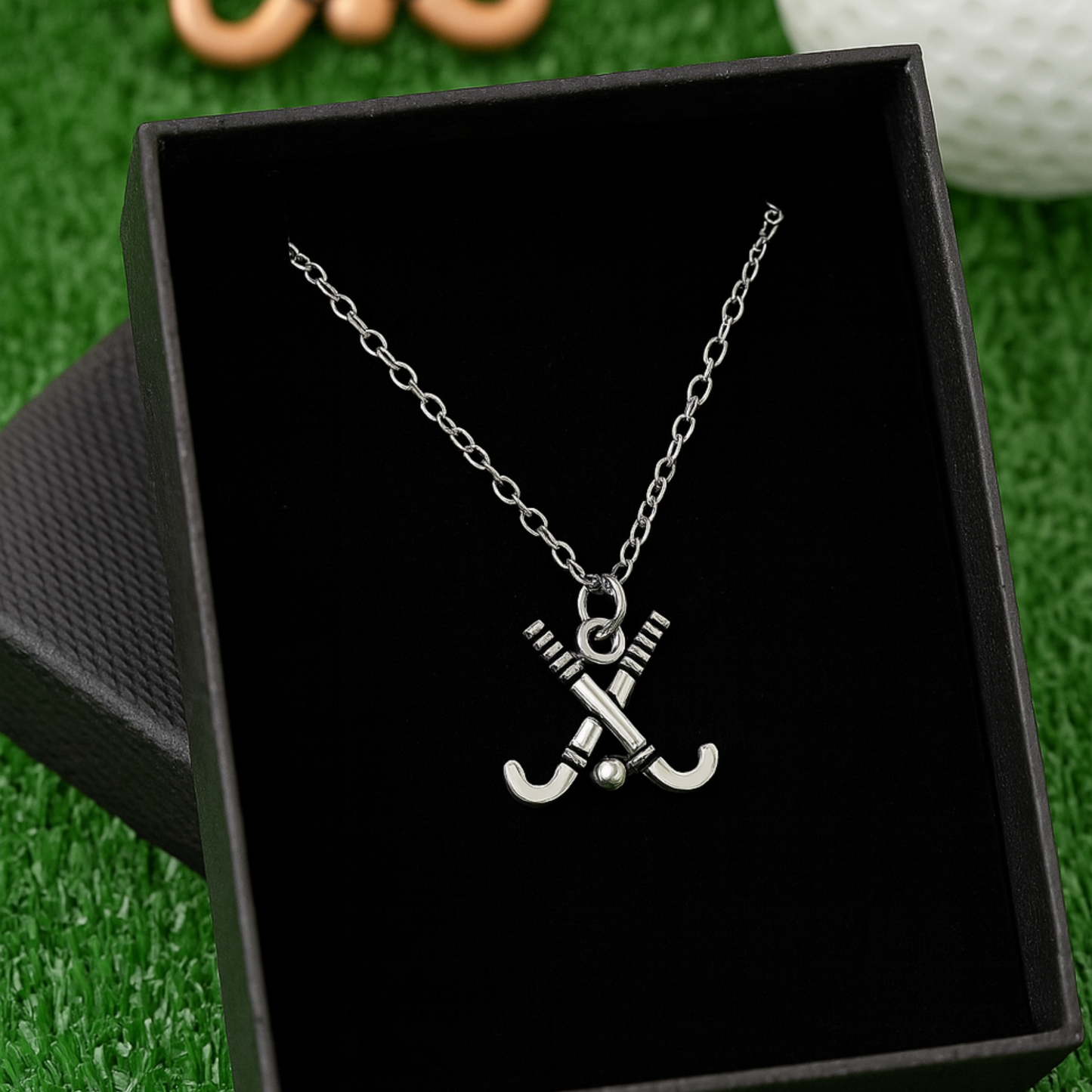 Close-up of silver field hockey necklace showing charm detail and chain