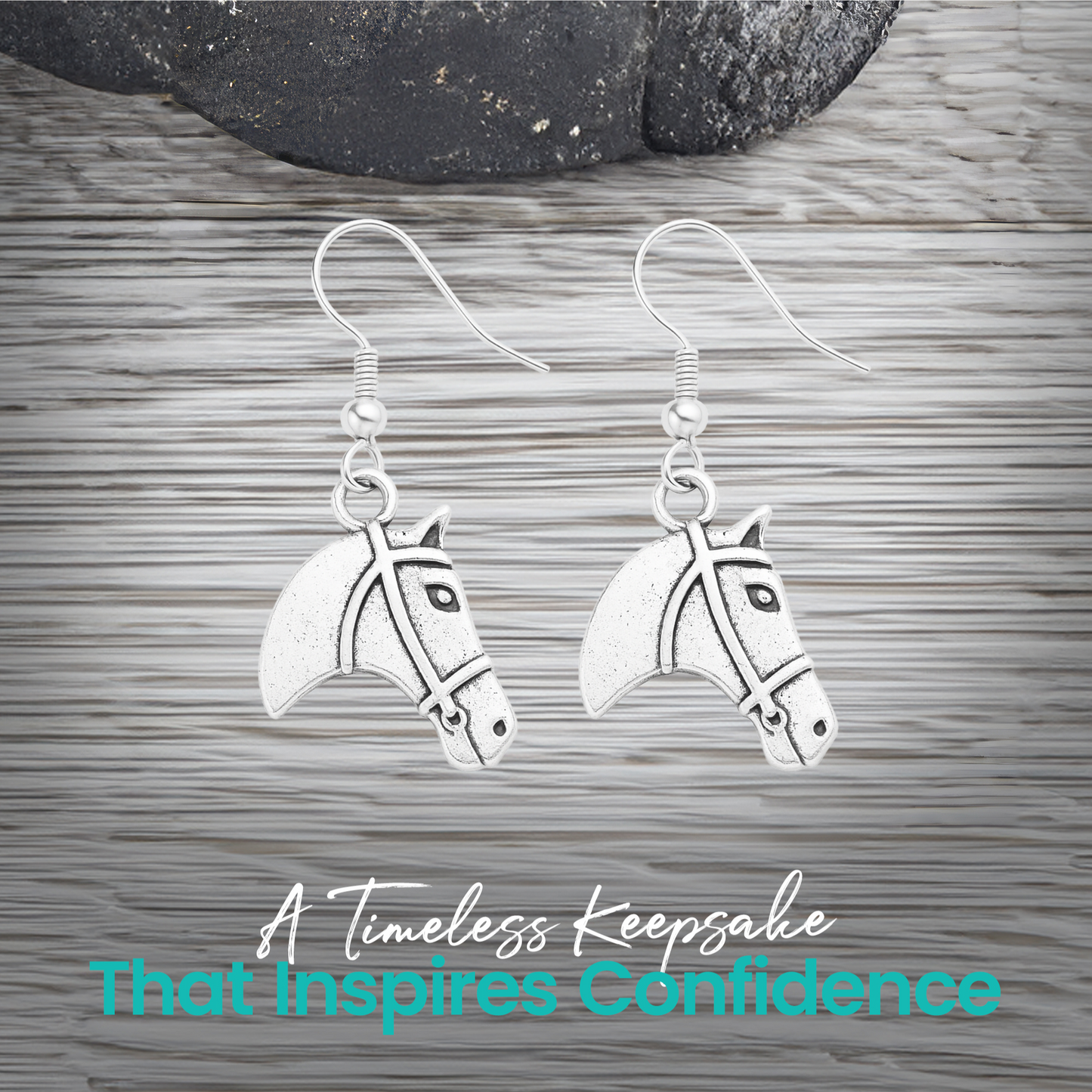 Silver horse head charm earrings displayed on rustic wood surface
