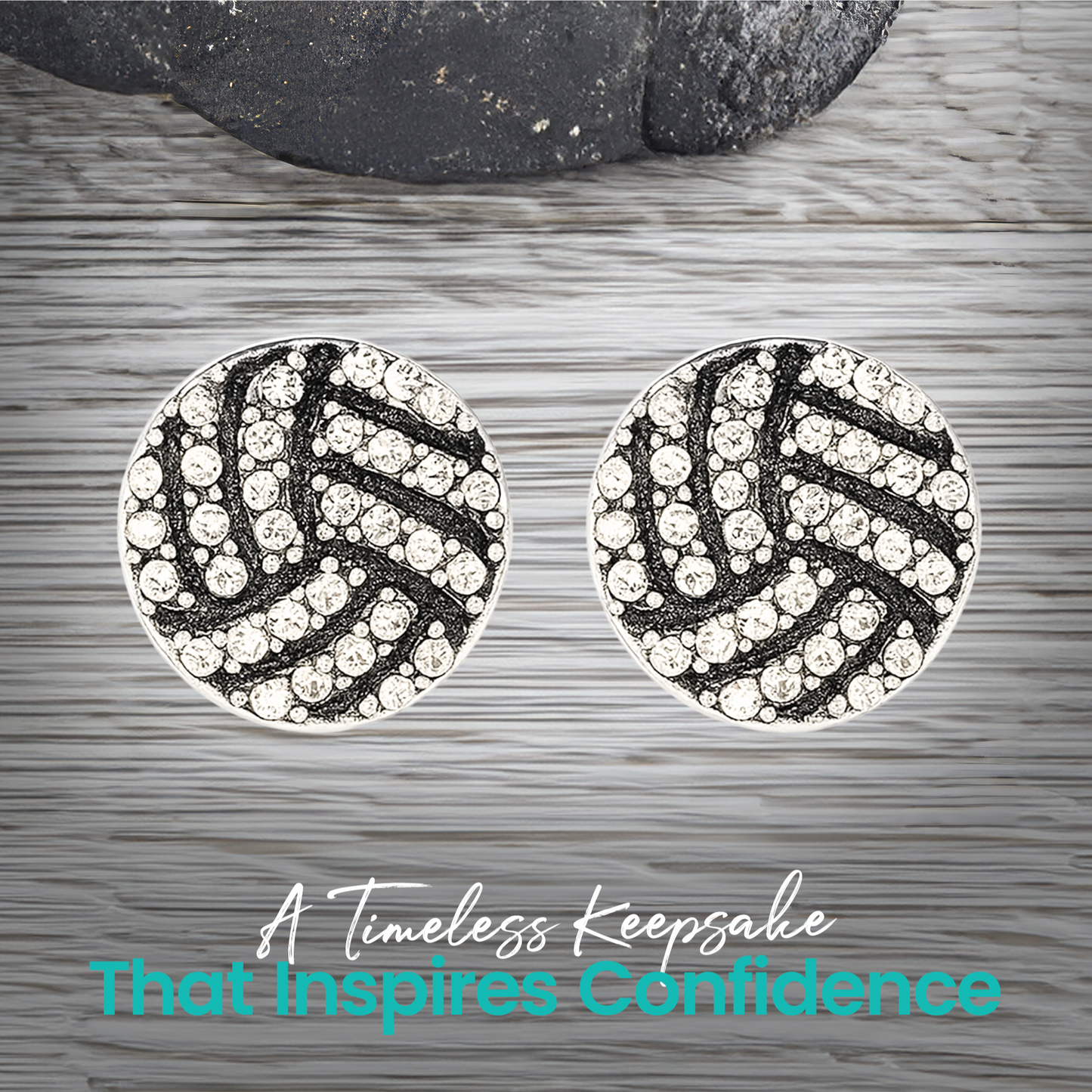 Pair of rhinestone volleyball earrings shown on gray wood surface, trendy everyday sports accessory for athletes