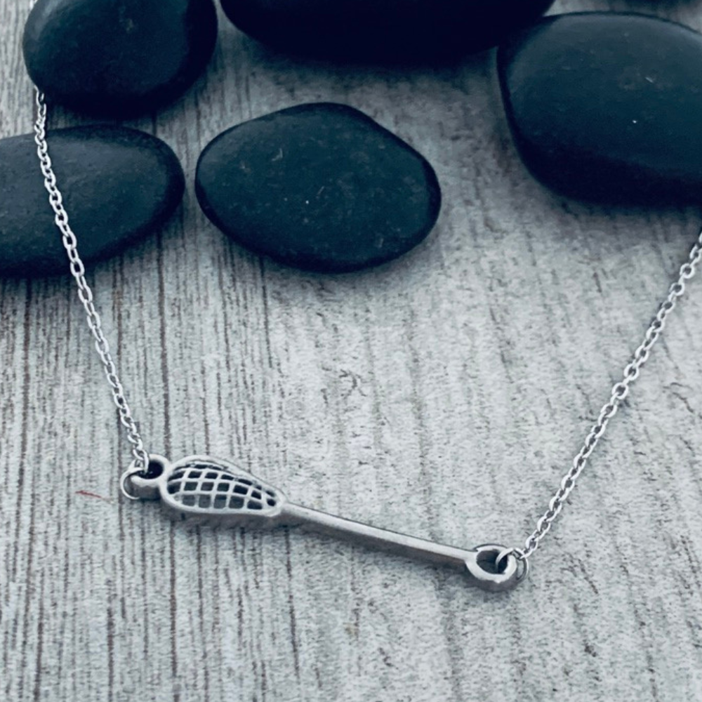 Stainless steel girls lacrosse charm necklace, tarnish-resistant and sporty