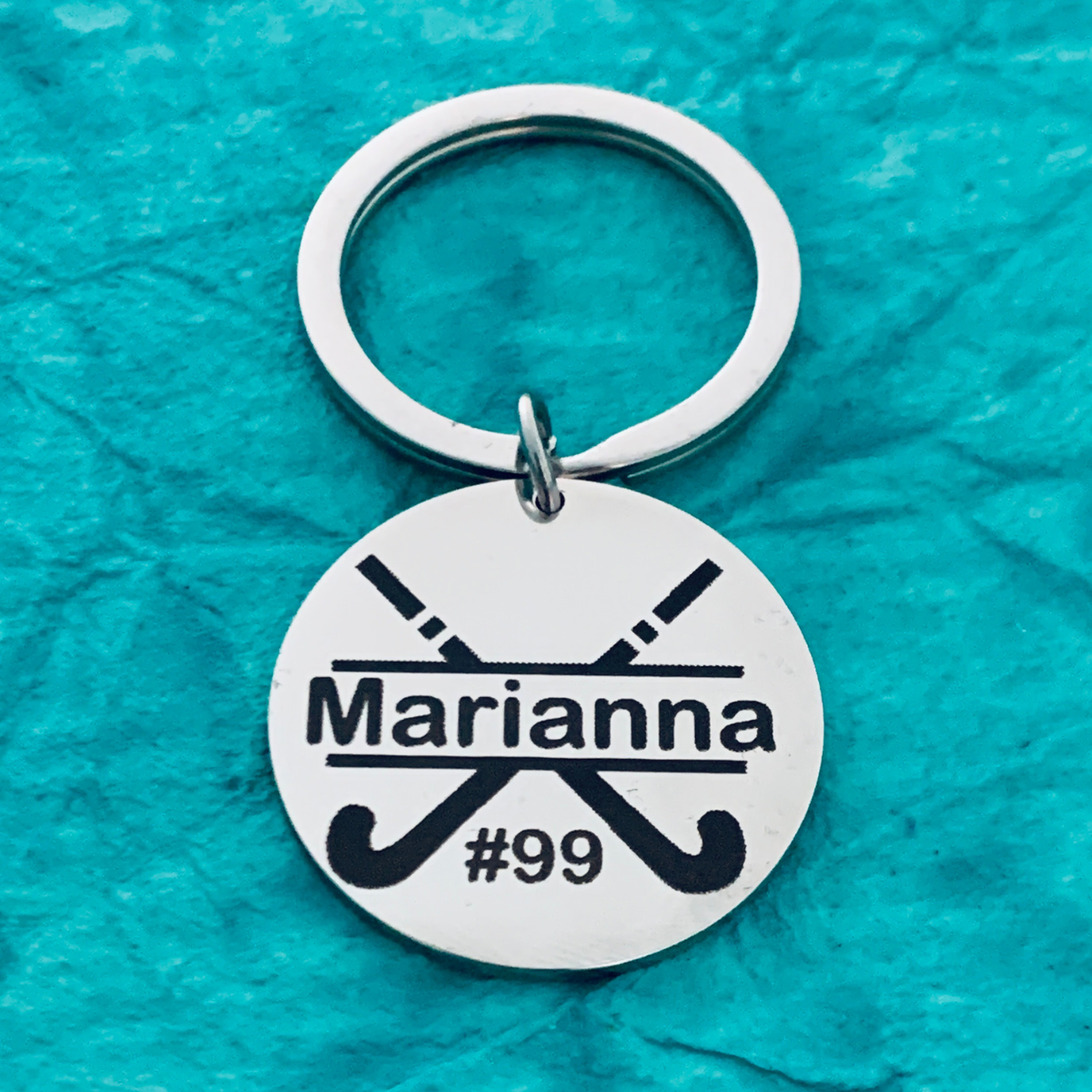 engraved stainless steel field hockey stick keychains labeled Team Gifts