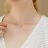 Girl wearing figure skating necklace, showcasing charm placement and size when worn