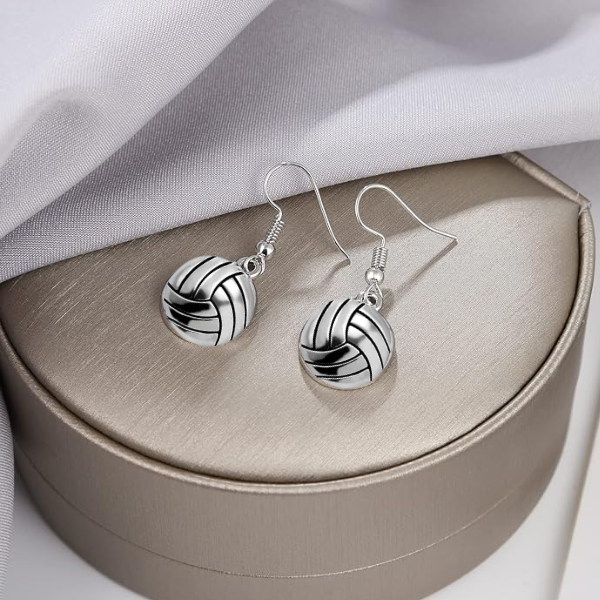 Volleyball charm earrings with silver finish displayed in round jewelry gift box