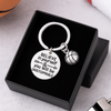 Flat-lay image of basketball keychain with engraved quote on wood background