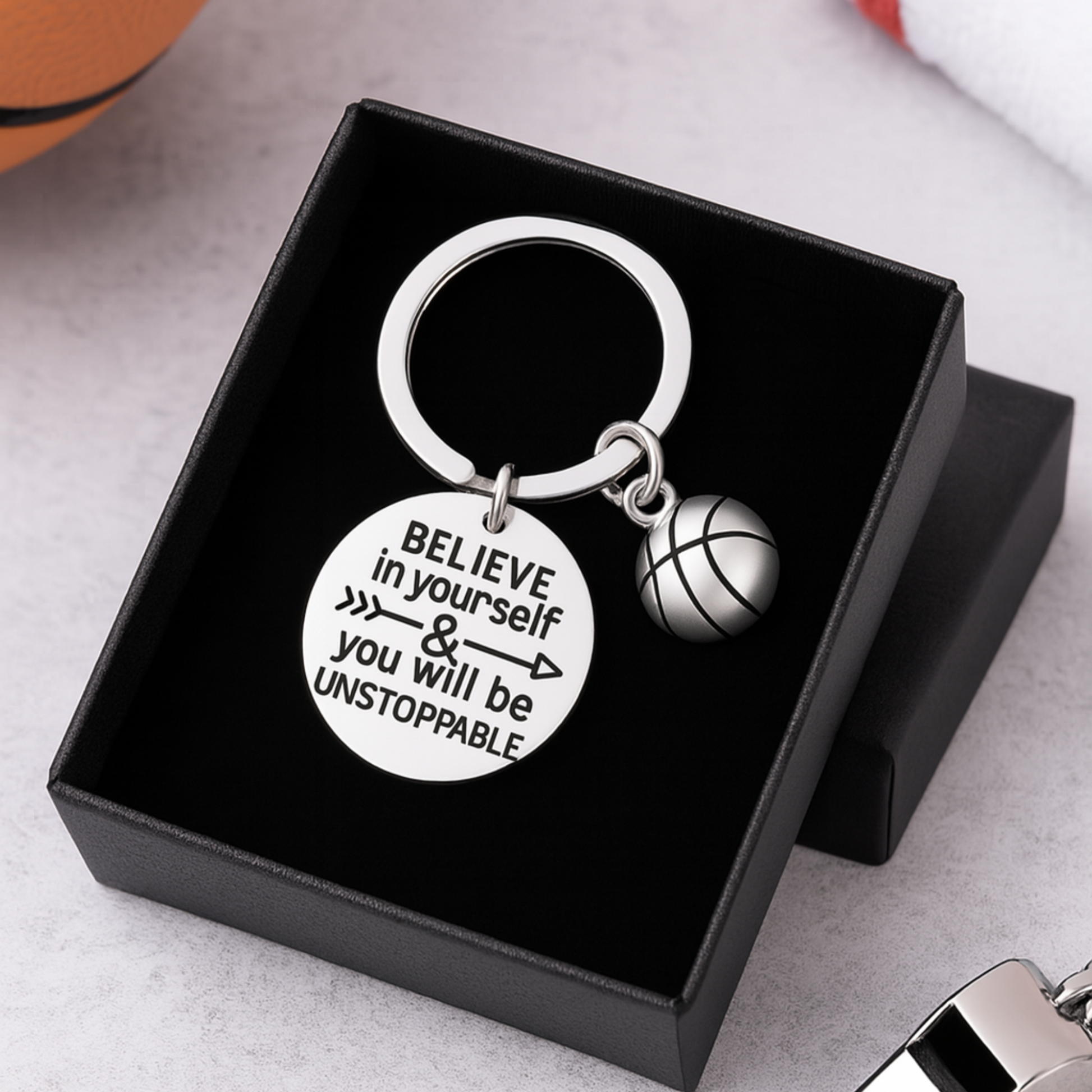 Flat-lay image of basketball keychain with engraved quote on wood background