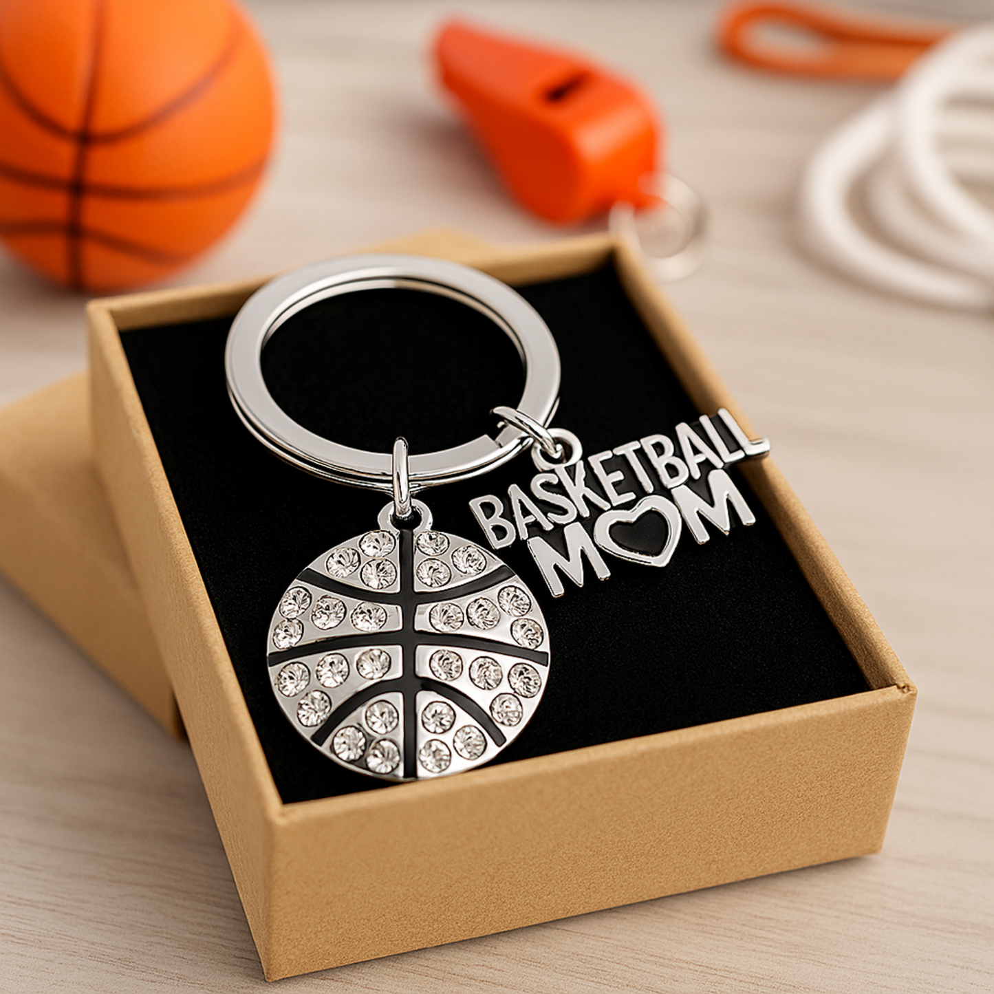 Basketball Mom rhinestone keychain displayed in gift box with basketball props in background