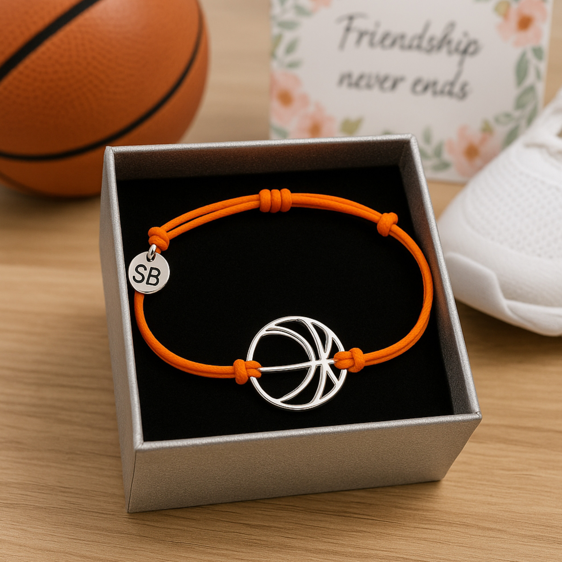Orange bracelet with stainless steel basketball charm and sliding knot design