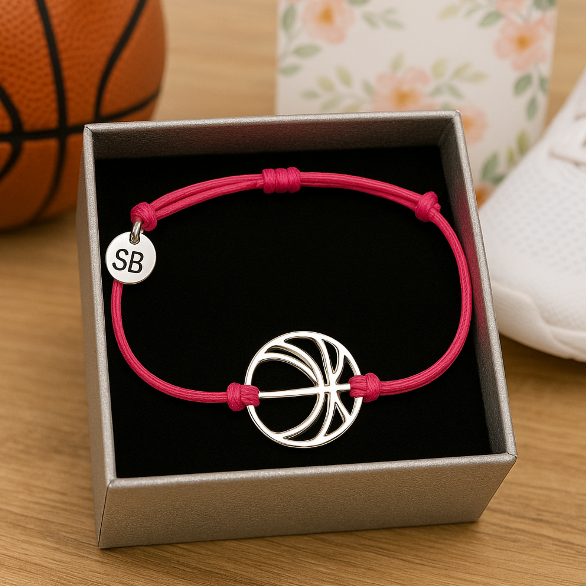 Pink rope bracelet featuring basketball charm and adjustable closure for girls