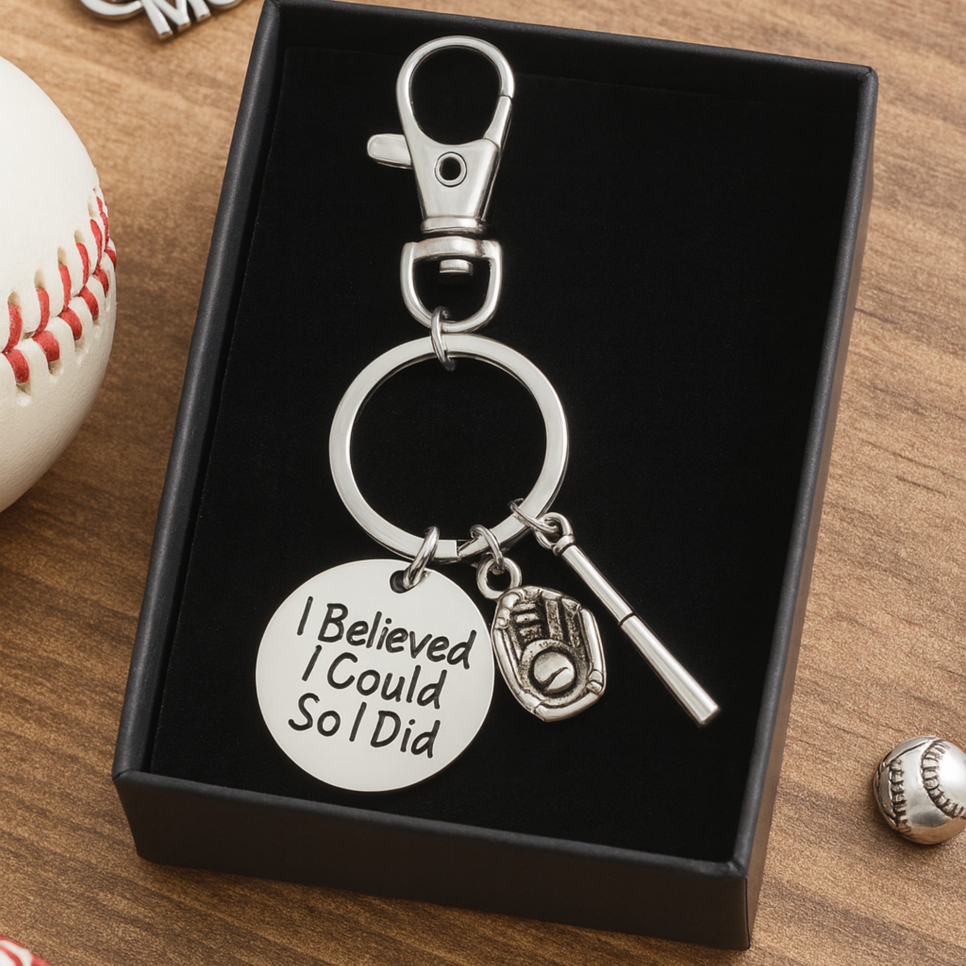 Gift-ready softball keychain placed on black box with baseball prop, perfect sports gift