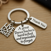 Close-up of engraved dance teacher keychain on wood surface, ideal gift for instructors