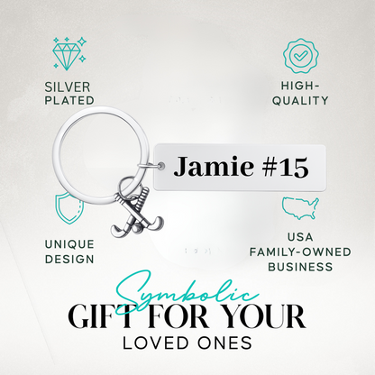 Engraved stainless steel bar keychain with field hockey charm in gift-ready packaging