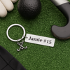 Personalized bar field hockey keychain displayed on turf with stick, ball, and name engraving