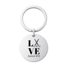 Stainless steel engraved field hockey keychain with LOVE design and custom name on white background