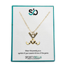 Elegant gold field hockey charm necklace displayed on gift-ready card – perfect team or coach gift