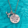 Field hockey She Believed She Could So She Did necklace with charm displayed on teal surface