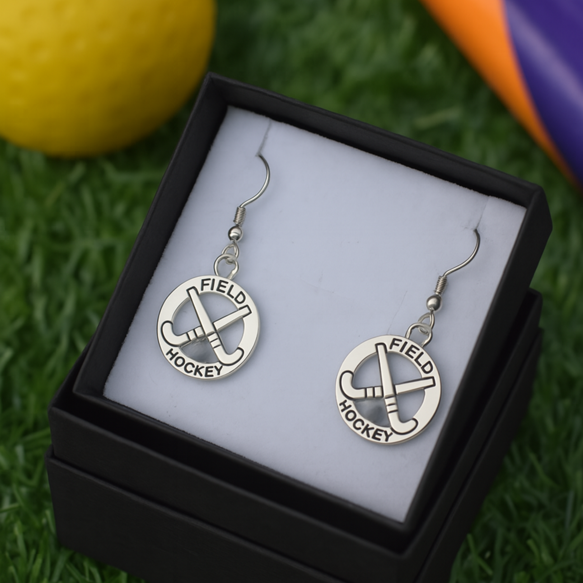 Teen girl wearing field hockey earrings, perfect sporty jewelry gift for players and fans