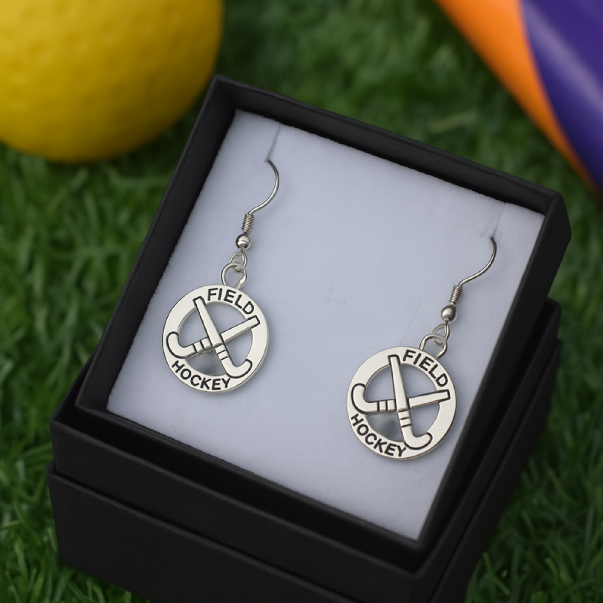 Teen girl wearing field hockey earrings, perfect sporty jewelry gift for players and fans