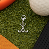 Field hockey zipper pull charm on artificial turf with hockey ball and stick background