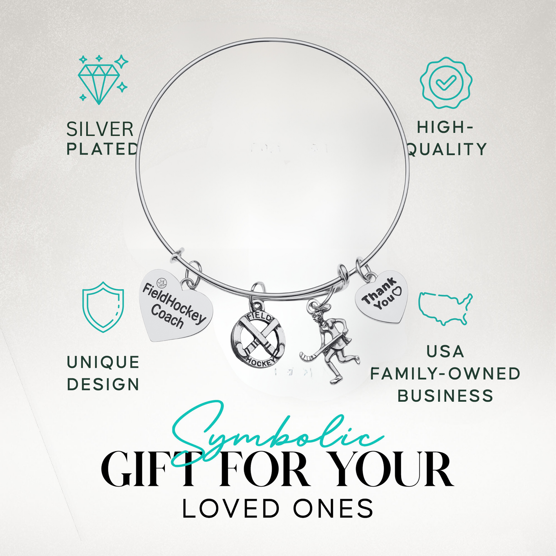 Adjustable silver coach bangle bracelet with engraved charms shown on turquoise background with product features