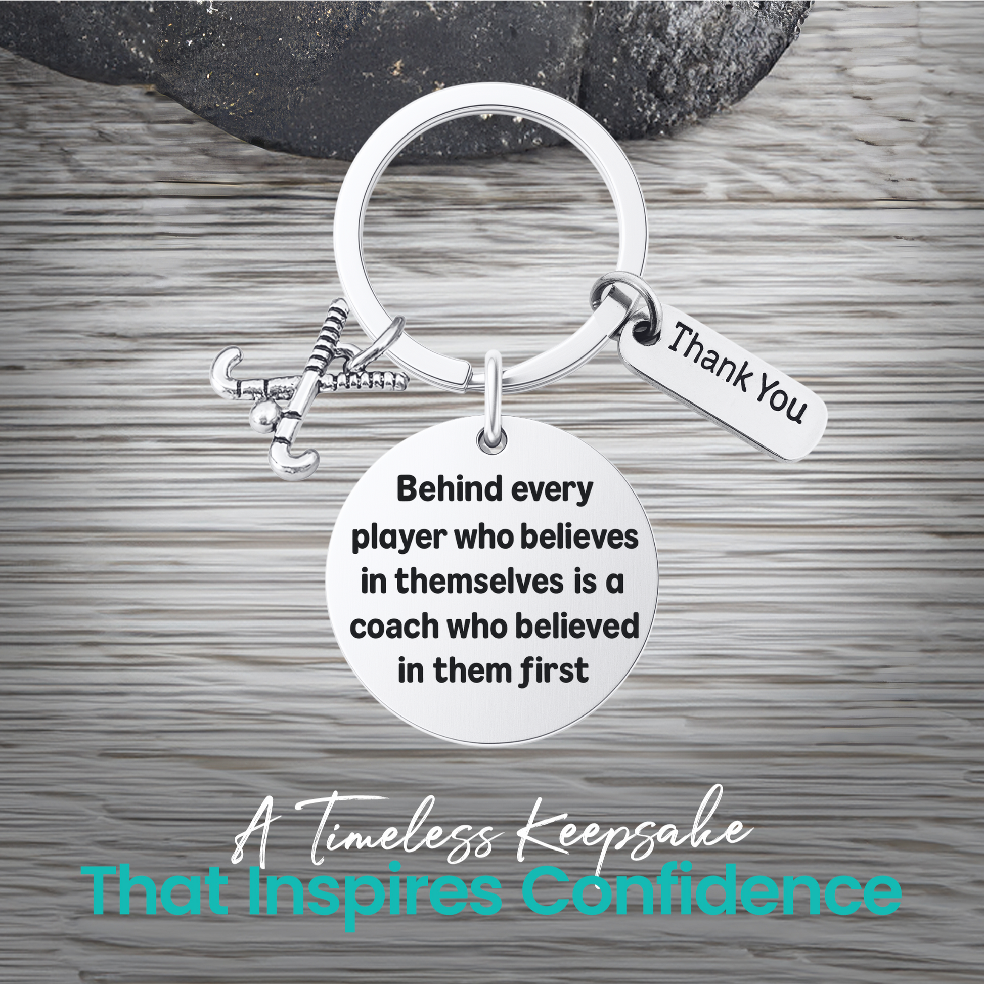 Silver field hockey coach keychain with inspirational Behind Every Player engraving on rustic wood