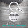 Silver coach keychain with engraved Great Coach Can Change a Life quote on rustic wooden surface