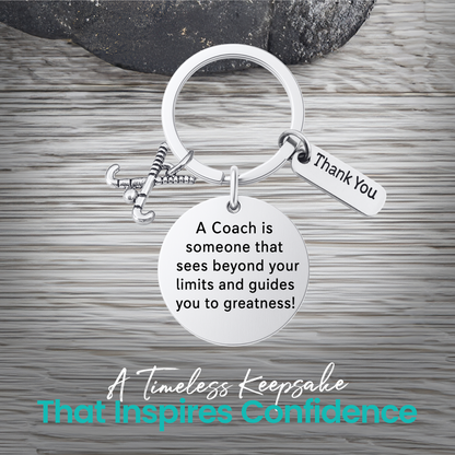 Silver coach keychain with engraved Sees Beyond Your Limits charm on rustic wood background