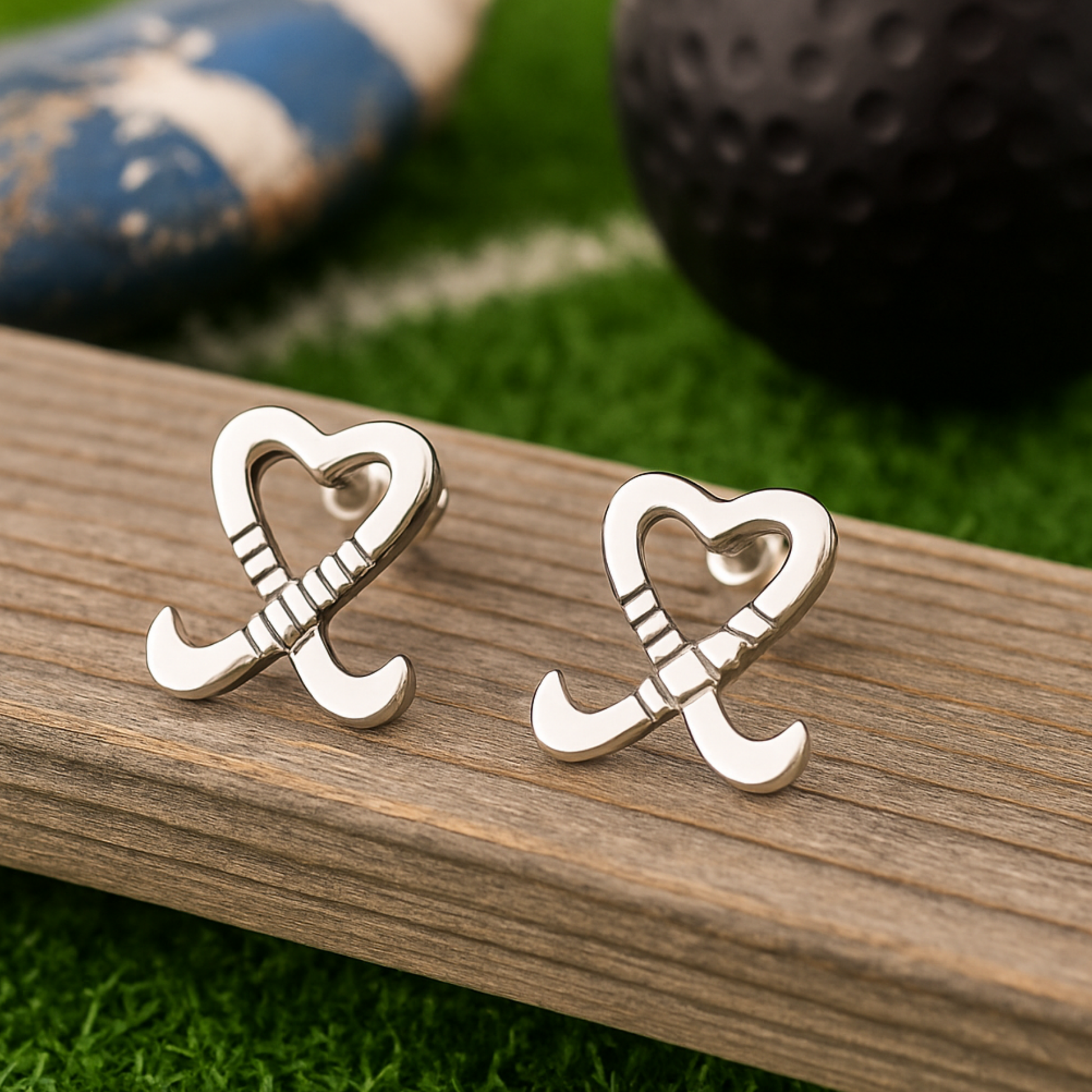 Sportybella field hockey earrings photographed on wood background with athletic gear