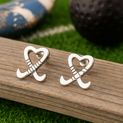Sportybella field hockey earrings photographed on wood background with athletic gear