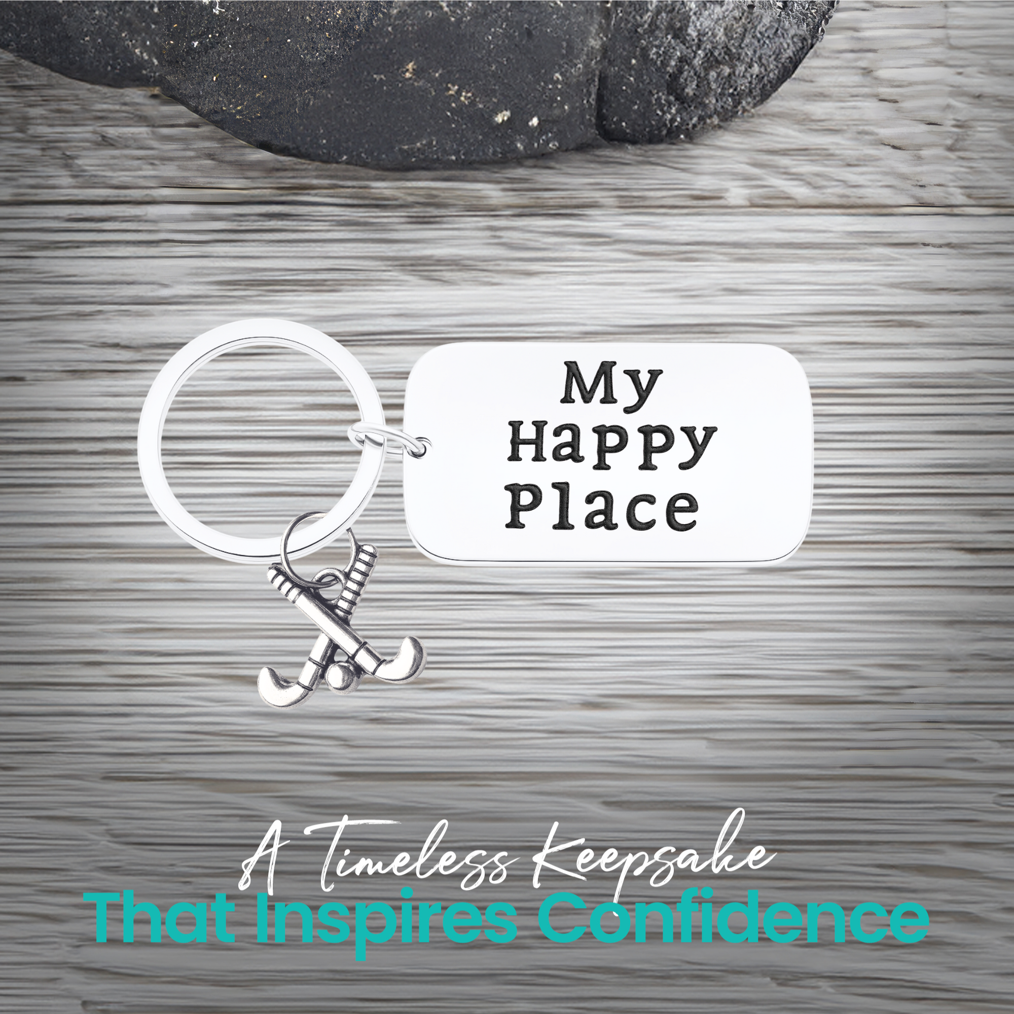Close-up of field hockey keychain with My Happy Place engraving on rustic wood background
