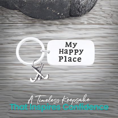 Close-up of field hockey keychain with My Happy Place engraving on rustic wood background