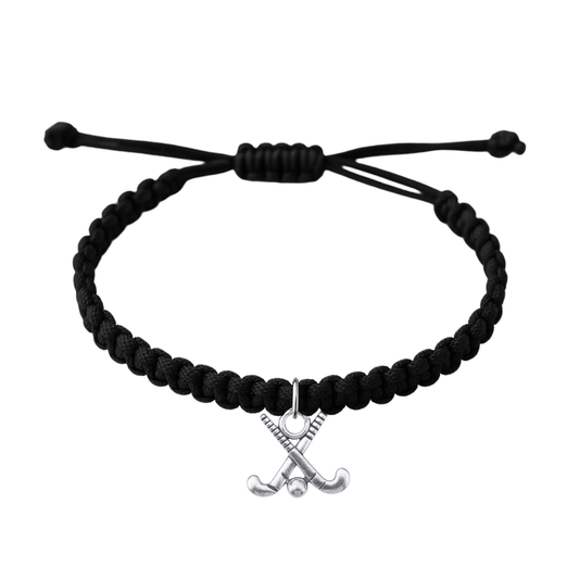 Adjustable black rope field hockey bracelet with crossed sticks charm on white background