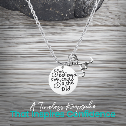 Silver She Believed She Could So She Did field hockey necklace on rustic wooden surface