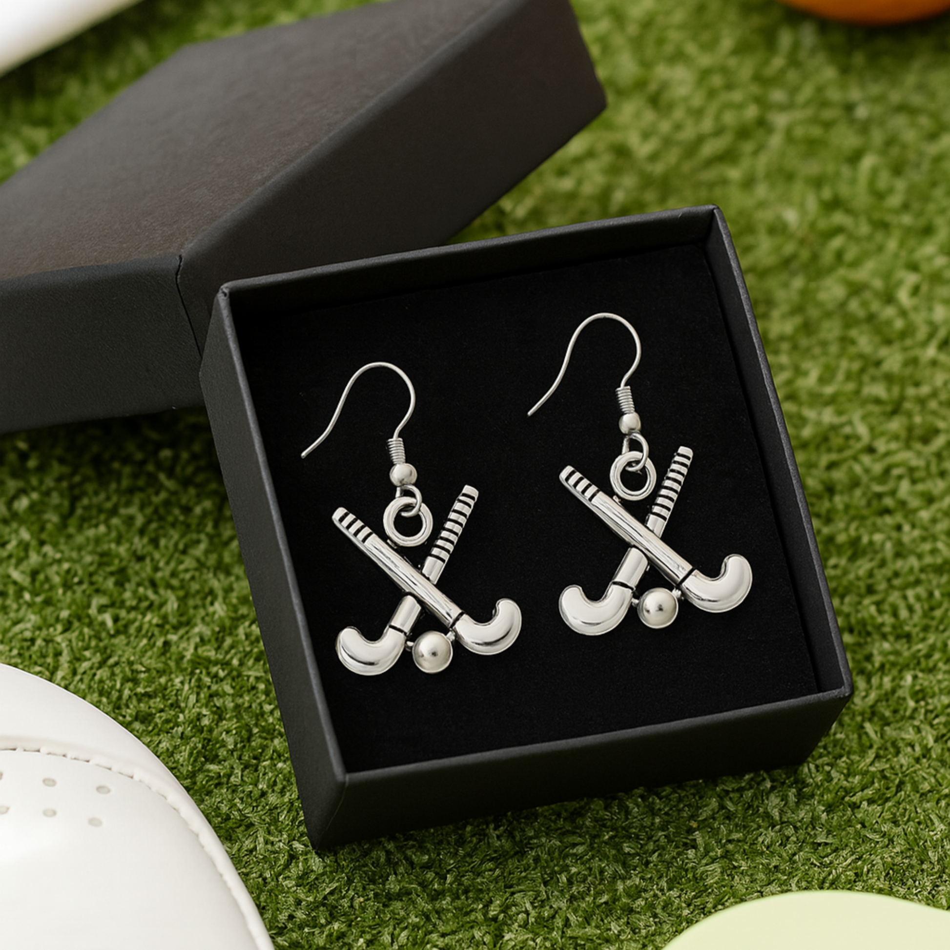 Field hockey stick earrings displayed in gift box, ideal present for coaches and teammates