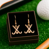 Dangle field hockey earrings styled on artificial turf, sporty packaging for athletic gift