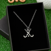 Close-up of silver field hockey necklace showing charm detail and chain