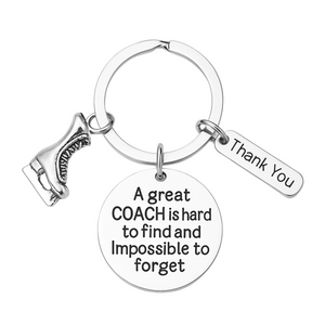 Silver figure skating coach keychain with engraved quote 'A great coach is hard to find and impossible to forget' and thank-you charm