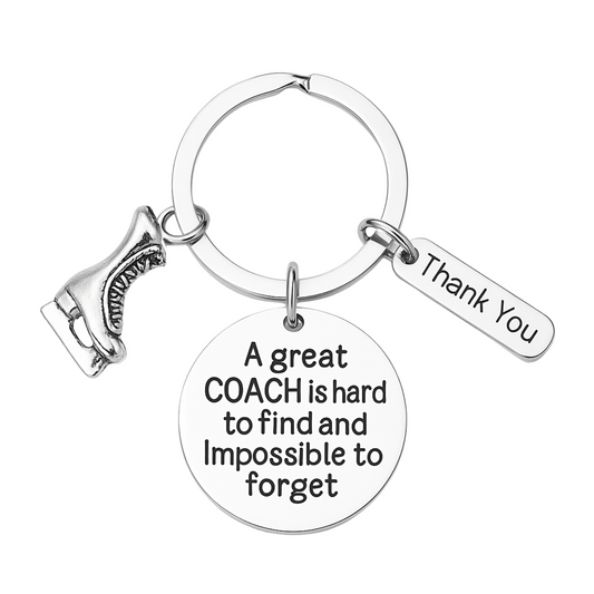 Silver figure skating coach keychain with engraved quote 'A great coach is hard to find and impossible to forget' and thank-you charm