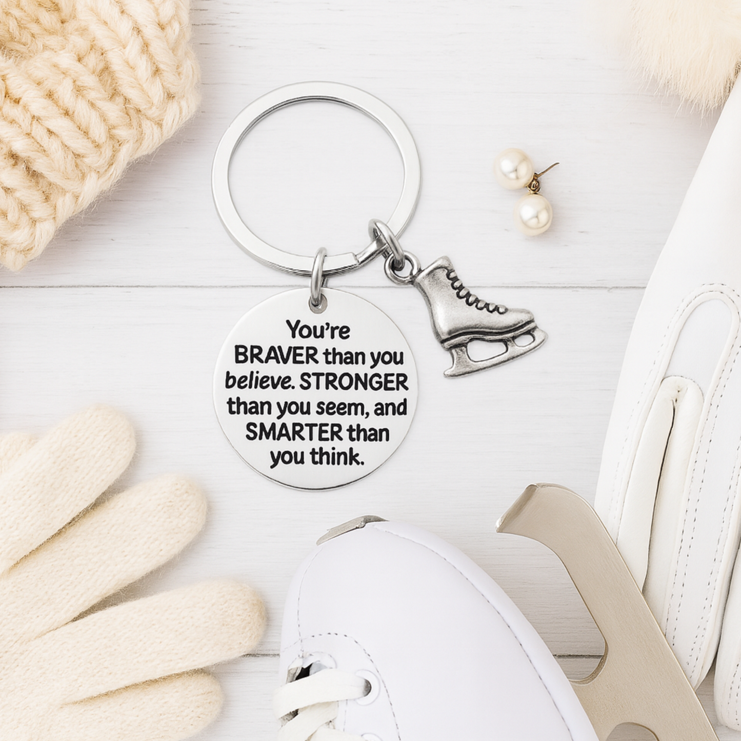 Inspirational figure skating keychain with engraved quote and skate charm displayed on neutral background