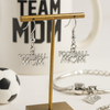 Football Mom earrings displayed with soccer ball and Team Mom sign