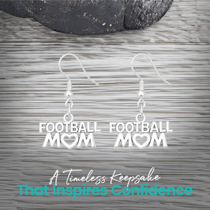 Silver Football Mom earrings displayed on rustic wooden surface