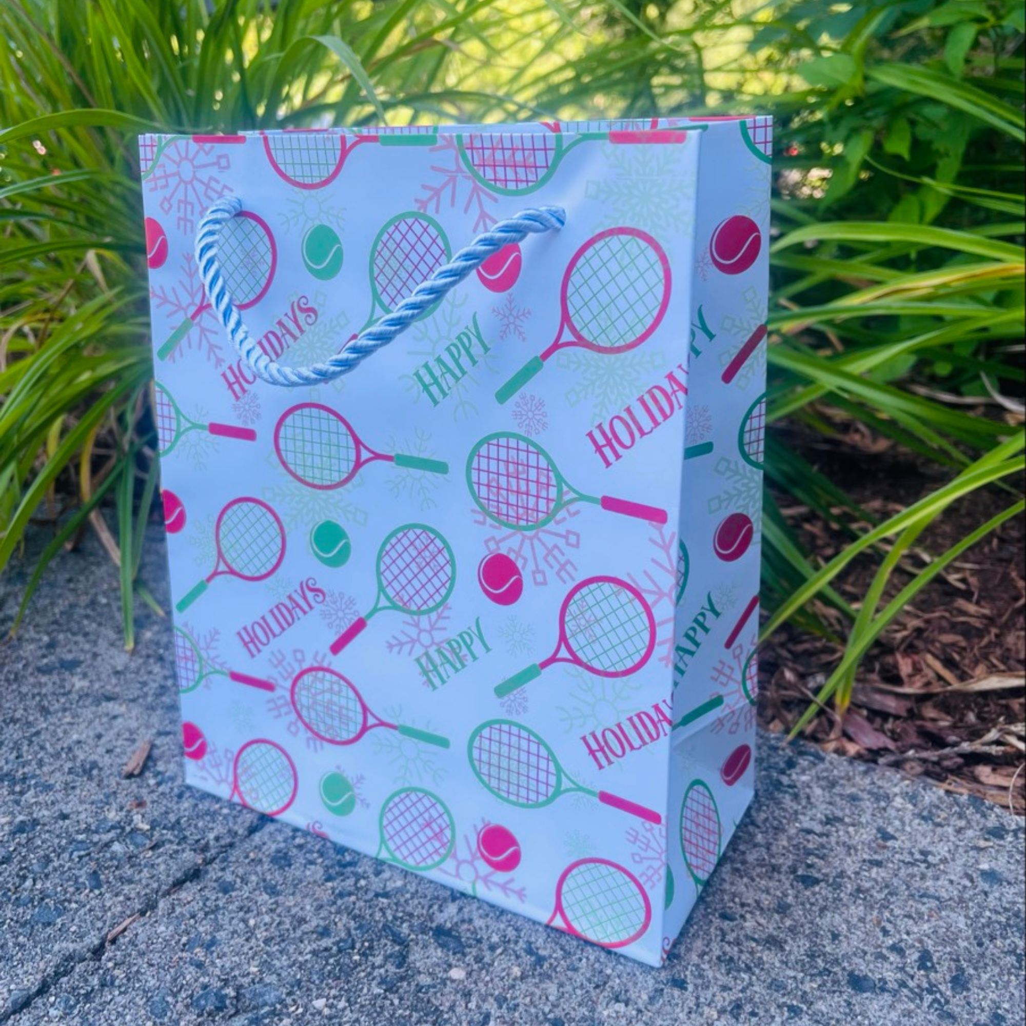 Tennis holiday gift bag with festive racket and ball designs, perfect for tennis lovers and accessories enthusiasts.