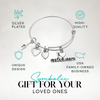 Silver gymnastics bracelet with heart and gymnast charms, shown on display card with product info