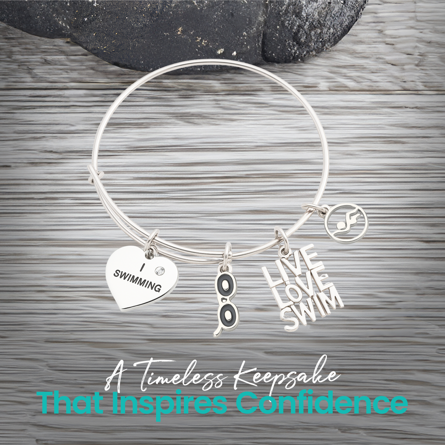 Expandable silver swim bracelet with motivational swim charms on rustic wood background