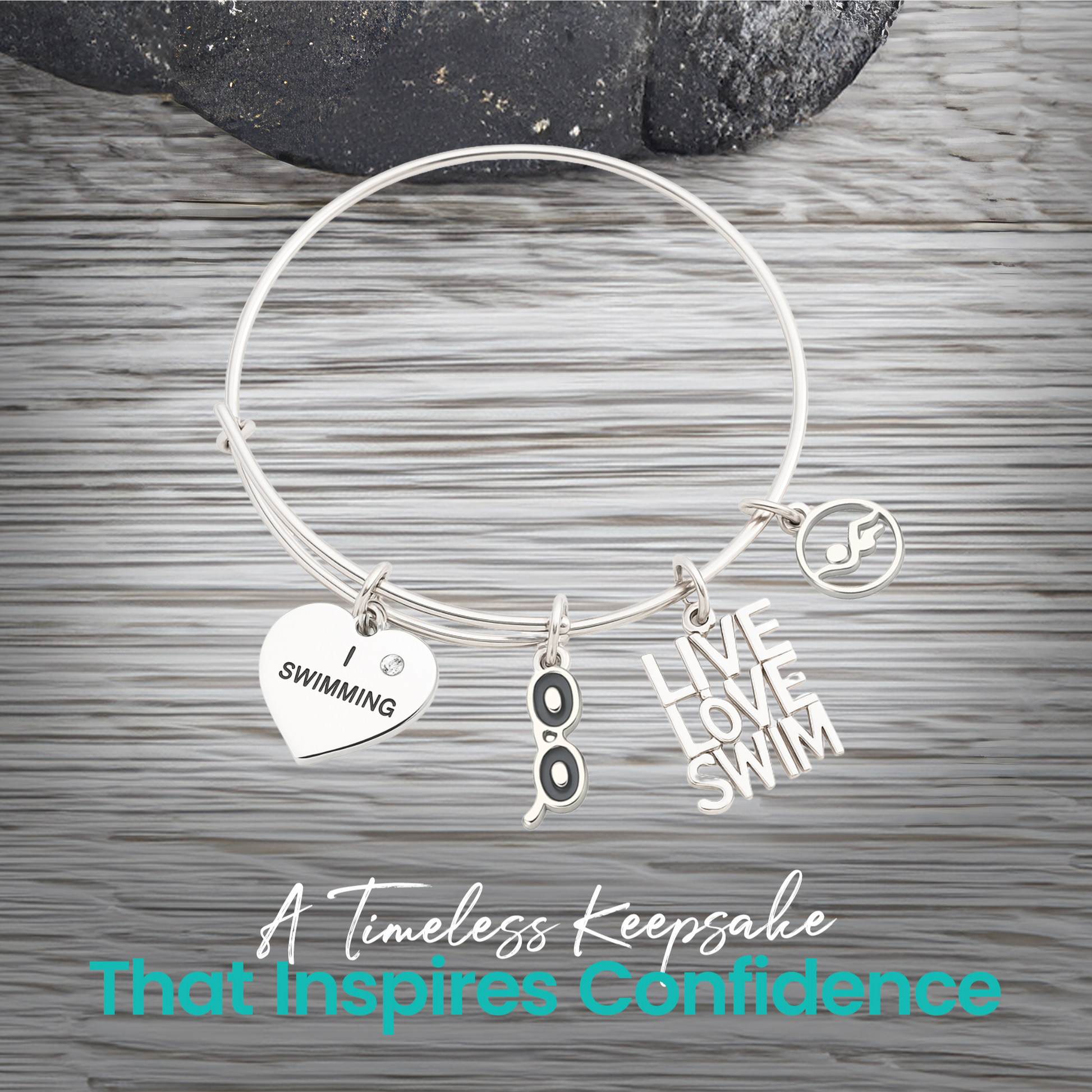 Expandable silver swim bracelet with motivational swim charms on rustic wood background