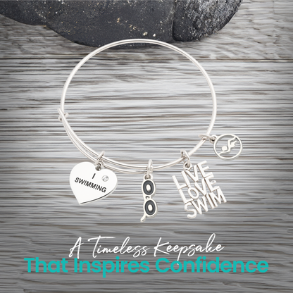 Expandable silver swim bracelet with motivational swim charms on rustic wood background