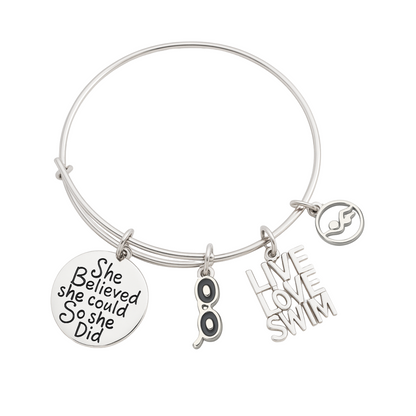 Silver swimmer bangle bracelet with 'She Believed She Could So She Did' charm, swimmer figure charm, and 'Love Swim' charm