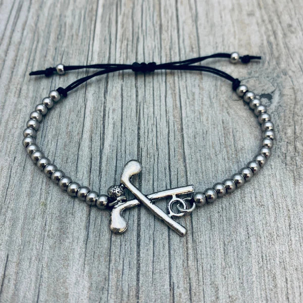 girls golf bracelet featuring silver-tone beads and a 3D golf charm with crossed clubs and ball