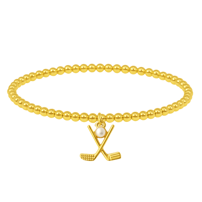Women’s beaded gold bracelet featuring a small charm of crossed golf clubs