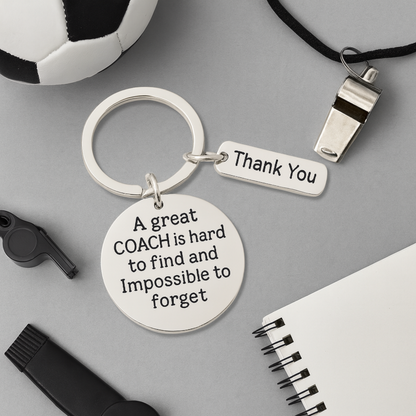 Coach appreciation keychain with engraved quote displayed alongside various sports equipment